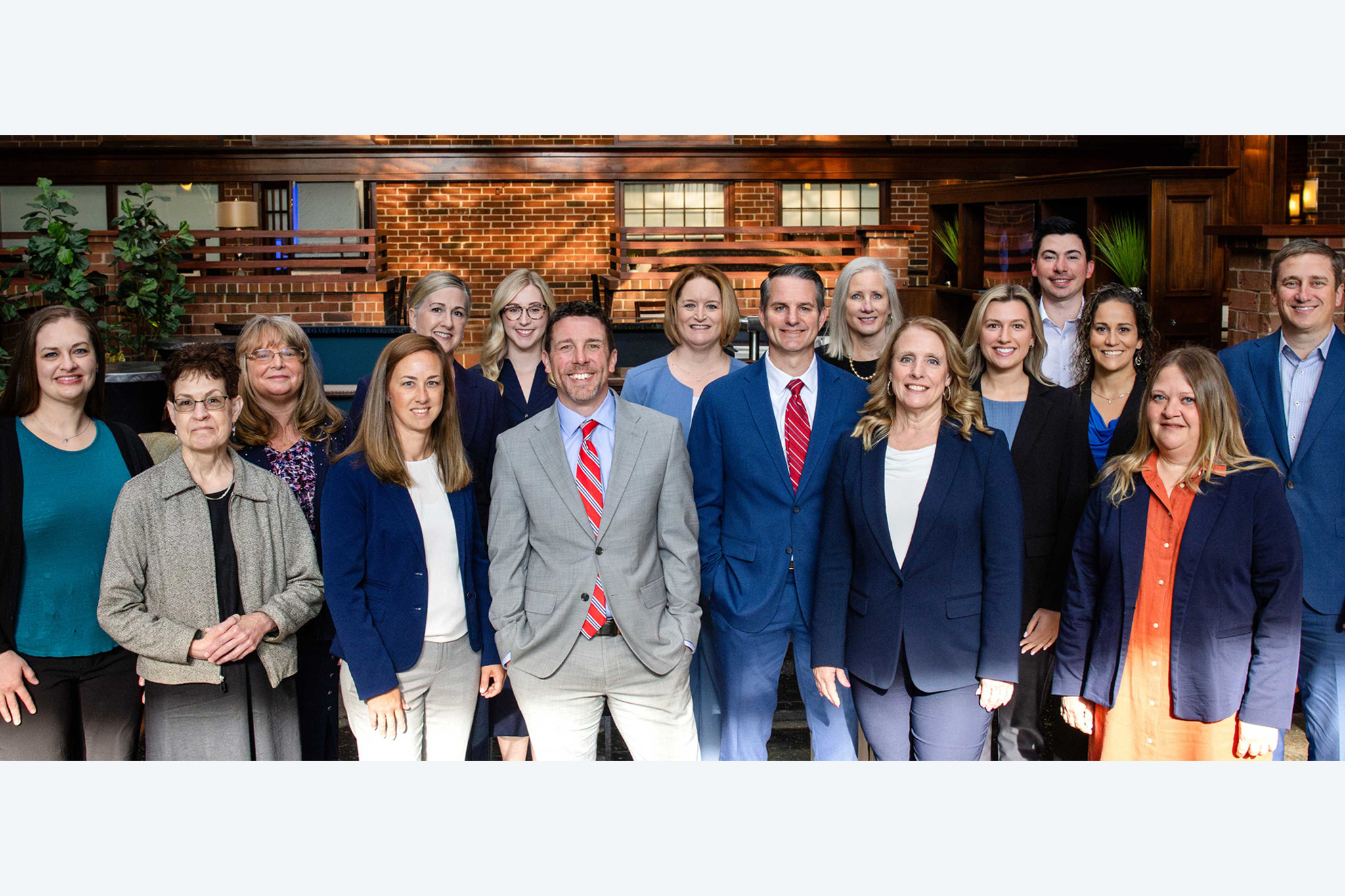 Mid Penn Bank insurance team members posing together in professional attire inside office environment